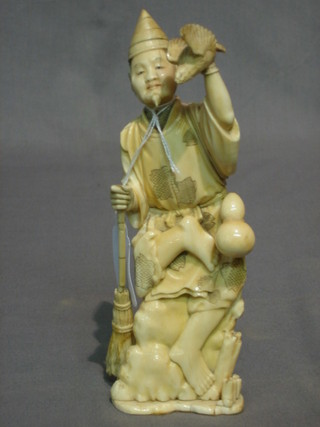 A 19th Century Japanese carved ivory figure of a standing sage with eagle in broom (head cracked, base f and r) 8"