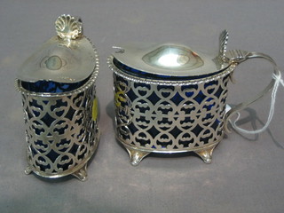 A handsome pair of Victorian oval pierced silver mustard pots Sheffield 1899, 5 ozs with blue glass liners (1 chipped)