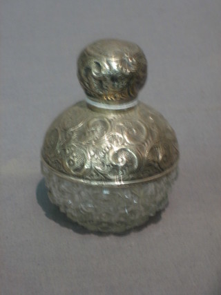 A Victorian globular shaped cut glass scent bottle with embossed silver mount 3"