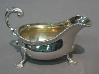 A Victorian, Georgian style silver cream jug with C scroll handle, raised on scroll supports London 1889, 8 ozs