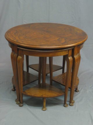 A circular Art Deco walnut nest of 4 interfitting coffee tables, raised on cabriole supports 26"
