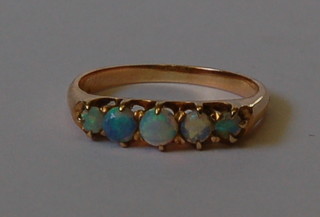 An 18ct gold dress ring set 5 graduated opals
