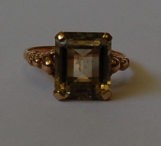 A 9ct gold dress ring set a rectangular cut brown stone
