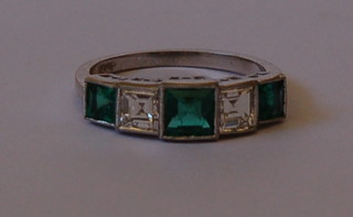 A lady's 18ct white gold dress ring set 3 square cut emeralds and 2 diamonds approx 0.80/1.25ct
