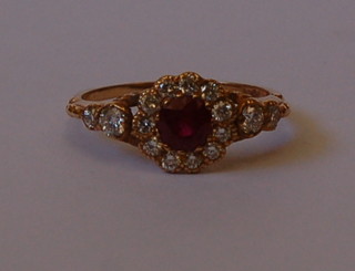 A lady's 18ct gold dress ring set circular cut rubies supported by numerous diamonds and 4 diamonds to the shoulders approx 0.60/0.80ct