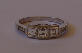 A lady's 18ct white gold dress ring set 3 square diamonds and 2 baguette cut diamonds to the corners approx 1.5ct