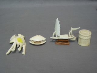 A cylindrical carved ivory trinket box 2", a model of a junk 2", a model of a camel 3" and a carved ivory model of a clam 2"