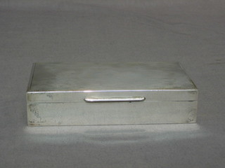 A rectangular silver cigarette box with engine turned decoration and hinged lid, Birmingham 1954, 6"