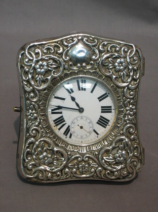A travelling watch with enamelled dial contained in a silver plated open faced case together with embossed silver outer case Birmingham 1899