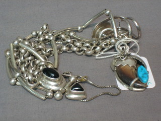 A pair of white metal earrings, 2 white metal necklaces and a white metal pendant hung on a silver chain