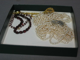 A seed pearl necklace, 2 bead bracelets and a gilt chain hung a cabouchon red stone
