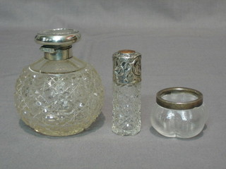 A globular shaped cut glass dressing table jar with silver lid 2", a salts bottle with silver lid 3" and a glass salt with silver rim