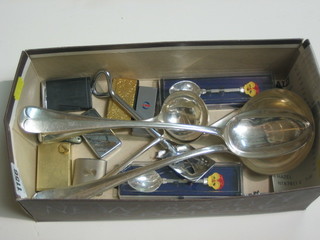 A collection of silver plated flatware and table lighters