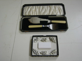 A pair of silver plated fish servers, cased and 6 silver plated postcard holders, boxed