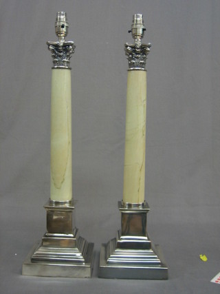 A pair of silver plated stepped electric table lamps with white marble columns and Corinthian capitals