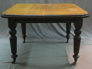 A Victorian walnut extending dining table, raised on turned and reeded supports 49"