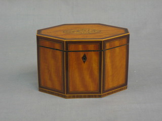 A 19th Century lozenge shaped twin compartment tea caddy, the top inlaid acorns and with crossbanding and satinwood stringing, 7"