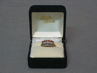 A lady's 18ct gold dress ring set a row of 6 diamonds supported by a row of 6 sapphires and 6 rubies