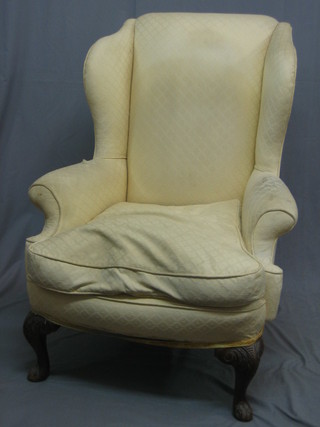 A Georgian style mahogany framed wing back armchair upholstered in yellow material