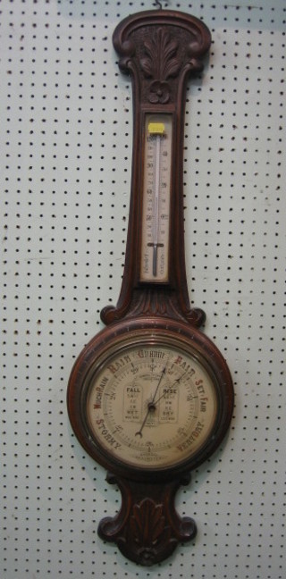 An aneroid barometer and thermometer with paper dial contained in a carved oak case, the dial marked Admiral Fitzroy's Indications