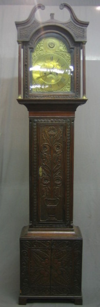 An 18th Century 8 day longcase clock, the 11" brass dial with gilt spandrels, Roman numerals and calendar aperture marked J N Weston of Walsingham no. 214, contained in a carved oak case 85"