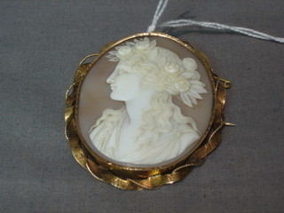 An oval shell carved cameo portrait brooch in the form of a head and shoulders portrait of a lady, contained in a gold brooch mount 2 1/2"
