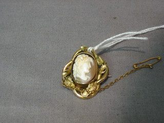 A small 19th Century shell carved cameo portrait of a classical lady, contained in a gilt brooch