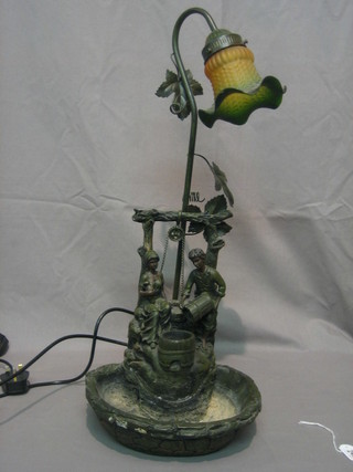An Art Nouveau style bronzed table lamp, the bottom incorporating a water feature