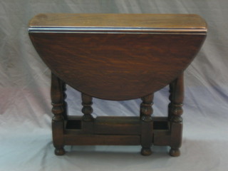 An 18th Century style oak drop flap gateleg tea table raised on turned and block supports (1 gate missing and f) 26"