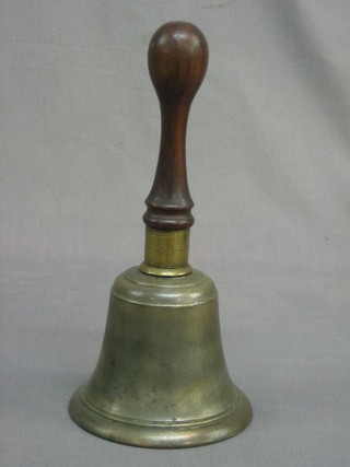 A brass bell with turned mahogany handle