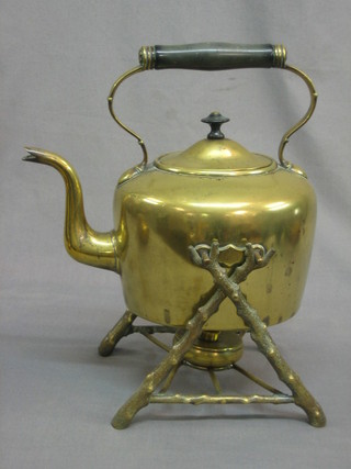 A Victorian cast tea kettle raised on a crab stock stand complete with burner