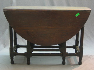 An 18th/19th Century oak oval drop flap gateleg dining table, raised on turned and block supports 42" (some old worm)