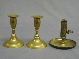 A pair of 19th Century brass stub shaped candlesticks with ejectors 5" and a do. chamber stick
