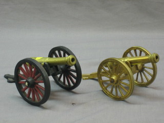 A model of a cannon with brass canon and iron trunion 8" and 1 other model of a cannon