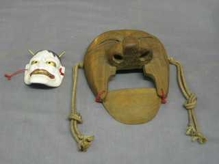 A carved Eastern wall mask 8" and 1 other 4" (2)