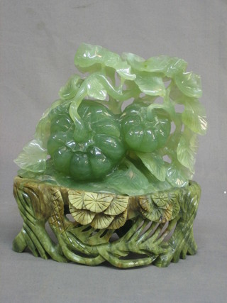 A carved Nephrite sculpture of flowers raised on a hardstone stand 6"