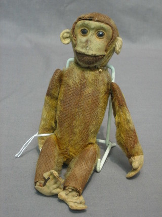A figure of a monkey with articulated limbs containing a scent bottle 8"