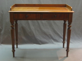 A Victorian mahogany wash stand with three-quarter gallery the base fitted 2 drawers above turned supports 36"