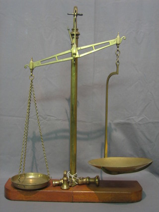 A pair of brass pan scales complete with 7 brass bell weights