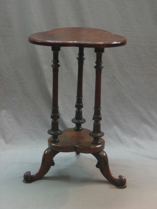 A Victorian figured walnut 2 tier occasional table raised on turned supports with outswept feet 18"