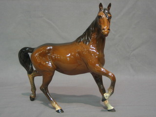 A Beswick figure of a prancing bay horse with right front hoof crooked 7"
