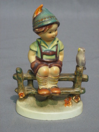 A Goebel figure of a seated boy on fence with whistling bird 4"