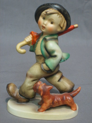 A Goebel figure of a boy with umbrella and dog 5"