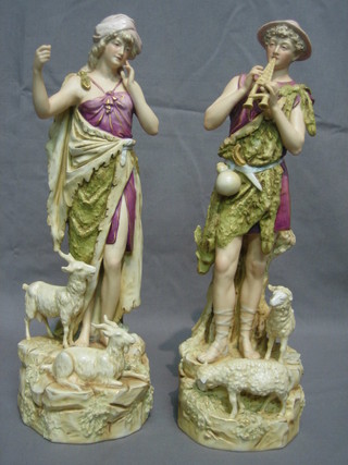 A pair of Royal Dux figures of classical Shepherd and Shepherdess with goats and sheep, bases impressed 135 and 136 and with pink Royal Dux mark (goats horn f and sheep's ear f) 15"