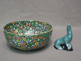 A blue glazed Poole Pottery figure of a dolphin 5" and a circular floral patterned Carltonware bowl 9"