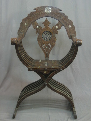 An X framed carved hardwood and inlaid Moorish folding chair