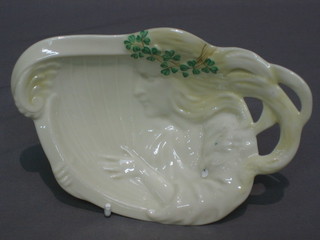 A Beleek dish in the form of a lady playing a harp, the reverse with black Beleek mark 7"