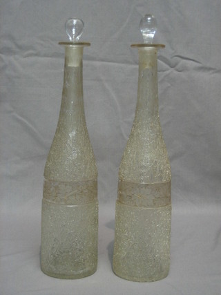 A pair of 19th/20th Century crackle glazed bottle shaped decanters with etched vinery decoration 13"