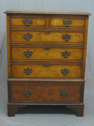 A Queen Anne style walnut chest with cross banded top, fitted 2 short and 4 long drawers, raised on bracket feet (in 2 sections) 30"