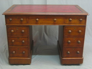 A Victorian oak kneehole pedestal desk with inset tooled leather writing surface about 9 drawers 40"